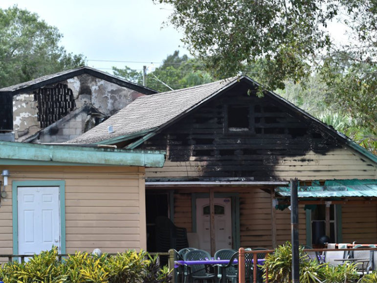 Fire-charred roofs of buildings at the Islamic Center of Fort Pierce are seen hours after the mosque was set on fire in an arson attack on Sept. 12, 2016, in White City, Fla. Photo courtesy of Eric Hasert, The (Stuart, Fla.) News