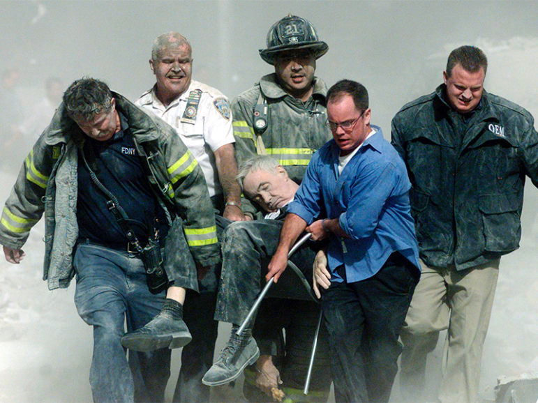 Rescue workers carry fatally injured New York City Fire Department chaplain, the Rev. Mychal Judge, from the wreckage of the World Trade Center in New York City on Sept. 11, 2001. Photo courtesy of REUTERS/Shannon Stapleton
*Editors: This photo may only be republished with RNS-9/11-PREPARE, originally transmitted on Sept. 9, 2016.