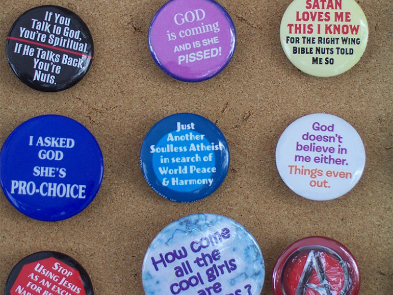 Atheism-themed buttons. Photo courtesy of Wikimedia Commons