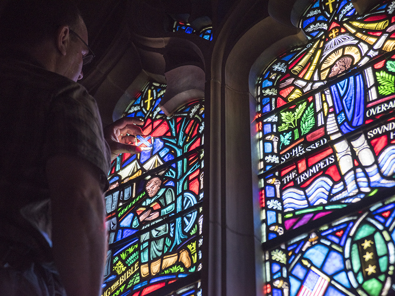 Andrew Goldkuhle of Goldkuhle Studios in Hanover, Va., inspects and replaces stained glass images of the Confederate battle flag at Washington National Cathedral. Photo courtesy of Danielle Thomas / Washington National Cathedral