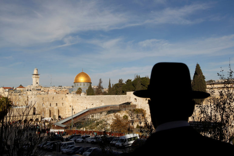 An ultra-Orthodox Jewish man stands at a viewpoint overlooking a wooden ramp leading up from Judaism's Western Wall to the sacred compound known to Muslims as the Noble Sanctuary and to Jews as Temple Mount, where the Al-Aqsa mosque and the Dome of the Rock shrine stand, in Jerusalem's Old City on Dec. 12, 2011. Photo courtesy of Reuters/Ronen Zvulun