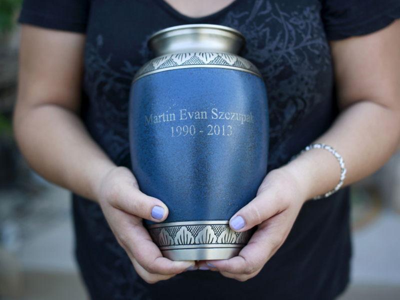 Inez Szczupak holds an urn filled with the ashes of her son Martin, who died of a drug overdose, outside her home in the Staten Island borough of New York on August 19, 2015.Photo courtesy of REUTERS/Shannon Stapleton *Editors: This photo may only be republished with RNS-VATICAN-CREMATION, originally transmitted on Oct. 25, 2016.