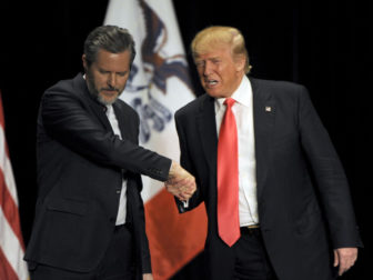 Republican presidential candidate Donald Trump, right, shakes hands with co-headliner Jerry Falwell Jr., leader of the nation's largest Christian university, during a campaign event at the Orpheum Theatre in Sioux City, Iowa, on Jan. 31, 2016. Photo courtesy of Reuters/Dave Kaup