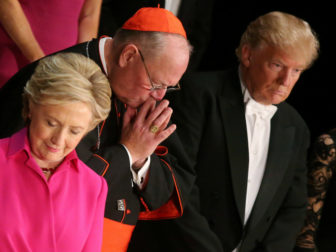Democratic presidential nominee Hillary Clinton, Archbishop of New York Cardinal Timothy Dolan, and Republican presidential nominee Donald Trump pray as they attend the Alfred E. Smith Memorial Foundation dinner to benefit Catholic charities in New York. October 20, 2016. Photo courtesy of Reuters/Carlos Barr