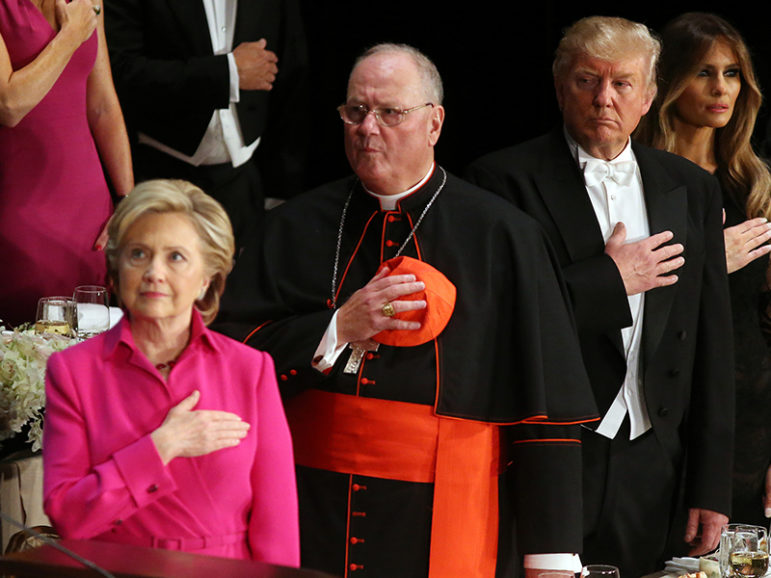 Republican U.S. presidential nominee Donald Trump looks at Democratic U.S. presidential nominee Hillary Clinton during the national anthem as they attend the Alfred E. Smith Memorial Foundation dinner to benefit Catholic charities in New York, on October 20, 2016. Photo courtesy of Reuters/Carlos Barria