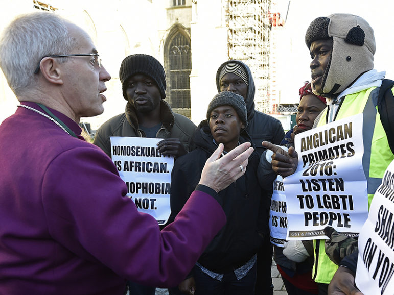 Archbishop of Canterbury Justin Welby, left, speaks with protesters on the grounds of Canterbury Cathedral in Canterbury, southern Britain, on Jan. 15, 2016. The Anglican Church has slapped sanctions on its liberal U.S. branch for supporting same-sex marriage, a move that averted a formal schism in the world's third largest Christian denomination but left deep divisions unresolved. The Anglican Communion, which counts some 85 million members in 165 countries, has been in crisis since 2003 because of arguments over sexuality and gender between liberal churches in the West and their conservative counterparts, mostly in Africa. Photo courtesy of REUTERS/Toby Melville
*Editors: This photo may only be republished with RNS-ANGLICAN-SAMESEX, originally transmitted on Oct. 5, 2015.