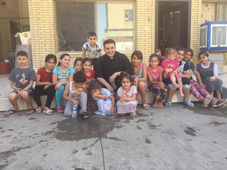 The Rev. Martin Banni with a group of displaced children from the Christian towns in Nineveh in Irbil. Banni spent much time playing with children and telling them stories from the Bible. Photo courtesy of Martin Banni