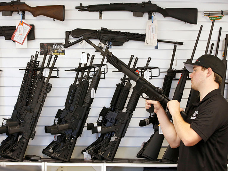 Salesman Ryan Martinez clears the chamber of an AR-15 at the Ready Gunner gun store In Provo, Utah, on June 21, 2016. Photo courtesy of Reuters/George Frey/File Photo
*Editors: This photo may only be republished with RNS-KRATTENMAKER-OPED, originally transmitted on Oct. 13, 2016.