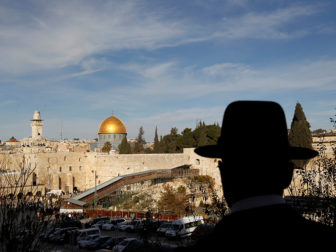 An ultra-Orthodox Jewish man stands at a point overlooking a wooden ramp leading up from Judaism's Western Wall to the sacred compound known to Muslims as the Noble Sanctuary and to Jews as Temple Mount, where the Al-Aqsa mosque and the Dome of the Rock shrine stand, in Jerusalem's Old City on Dec. 12, 2011. Photo courtesy of Reuters/Ronen Zvulun