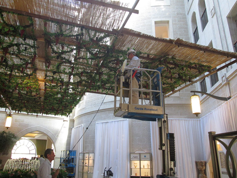 Workers have spent the past three weeks putting up the sukkas at the Waldorf Astoria Jerusalem hotel. Religious Jewish guests will eat many of their meals there.  RNS photo by Michele Chabin