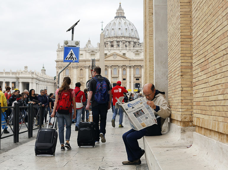 A man reads a newspaper in front of St. Peter's Square at the Vatican on April 8, 2016. Photo courtesy of Reuters/Alessandro Bianchi
*Editors: This photo may only be republished with RNS-VATICAN-DYLAN, originally transmitted on Oct. 14, 2016.