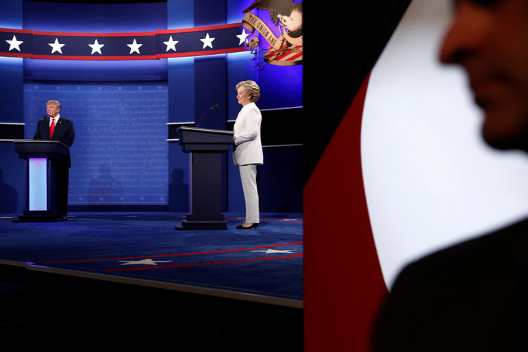 A Secret Service agent stands near the stage as Republican U.S. presidential nominee Donald Trump, left, and Democratic U.S. presidential nominee Hillary Clinton, center, begin their third and final 2016 presidential campaign debate at UNLV in Las Vegas, on October 19, 2016. Photo courtesy of Reuters/Jonathan Ernst