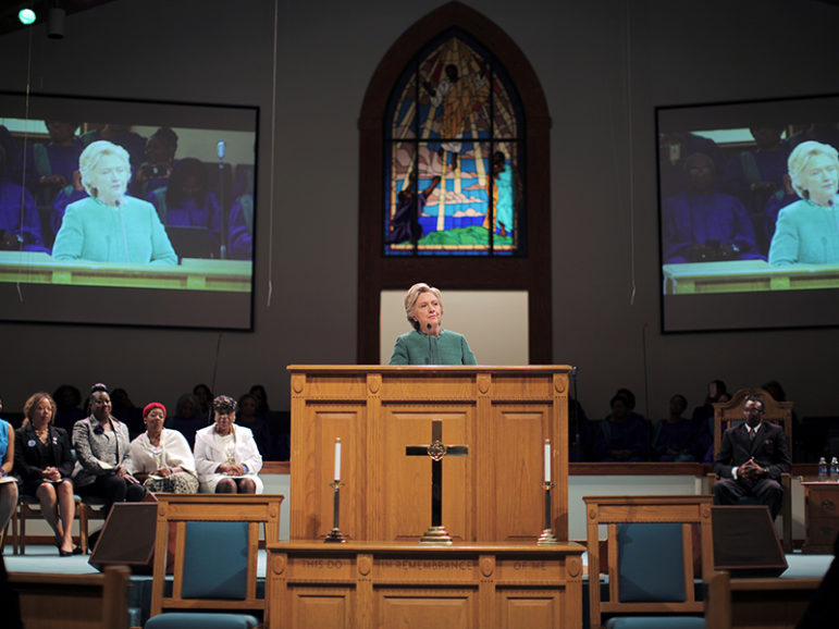 Democratic presidential nominee Hillary Clinton speaks at a Sunday service at Union Baptist Church accompanied by Mothers of the Movement, a group of women who have lost their children in a series of police shootings that galvanized the Black Lives Matter movement, in Durham, N.C., on Oct. 23, 2016. Photo courtesy of Reuters/Carlos Barria