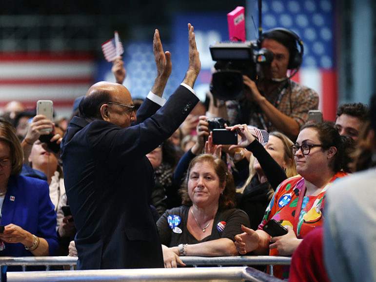 Khizr Khan, whose son Humayun S. M. Khan was one of 14 American Muslims who died serving in the U.S. Army in the 10 years after the 9/11 attacks, waves to Democratic presidential nominee Hillary Clinton's supporters Nov. 9, 2016, during her election-night rally in New York. Photo courtesy of/Carlos Barria