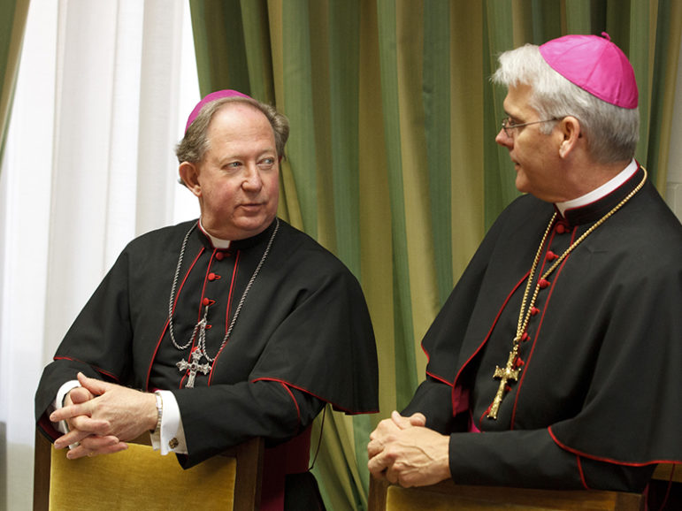 Bishop Patrick J. Zurek of Amarillo, Texas, left, and Archbishop Paul S. Coakley of Oklahoma City talk before a meeting of bishops from Texas, Oklahoma and Arkansas at the Congregation for Clergy on March 16 during their 