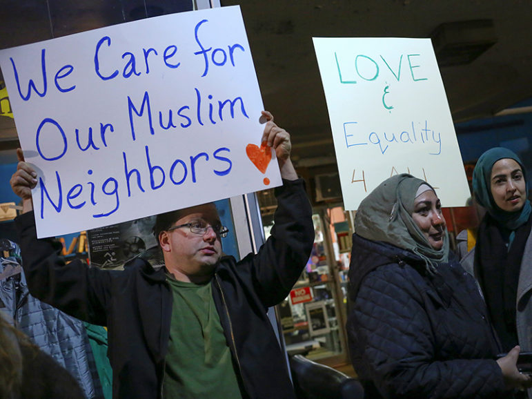 Demonstrators hold signs during a protest against President-elect Donald Trump and in support of Muslim residents in downtown Hamtramck, Mich., on Nov. 14, 2016. Photo courtesy of Reuters/Brittany Greeson
