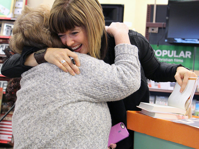 Author Ann Voskamp hugs a fan during a book signing on Friday, Oct. 29, at the Family Christian bookstore in Lombard, Ill. RNS photo by Emily McFarlan Miller.