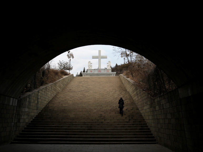 A villager climbs up the steps toward a cross near a Catholic church on the outskirts of Taiyuan, North China's Shanxi province, December 24, 2016. Picture taken on Dec. 24, 2016. Photo courtesy REUTERS/Jason Lee