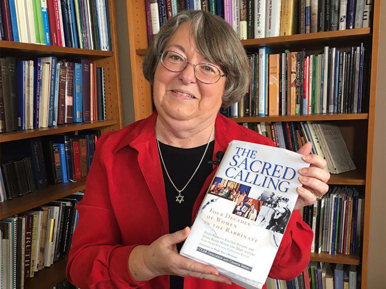 Rabbi Sally Priesand, the first American female rabbi, holds “The Sacred Calling” book of essays on female rabbis.  Photo courtesy of the Central Conference of American Rabbis