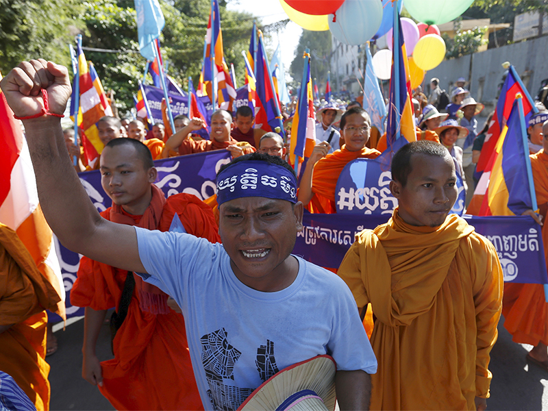 A man shouts as Buddhist monks march to celebrate Human Rights Day in Phnom Penh on Dec. 10, 2015. Photo courtesy of Reuters/Samrang Pring