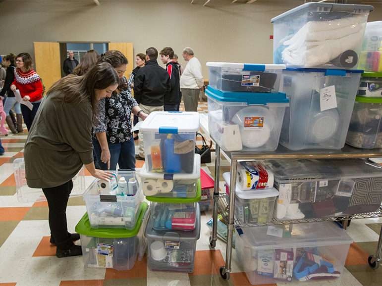 Becky Conrad, left, and Zandee Bahr inventory welcome kits between services at Lakeland Community Church in Lee’s Summit, Mo., on Dec. 11, 2016. Both women are part of the church’s redemptive community, Welcoming the Stranger, which looks for opportunities to help migrants and refugees. RNS photo by Kit Doyle