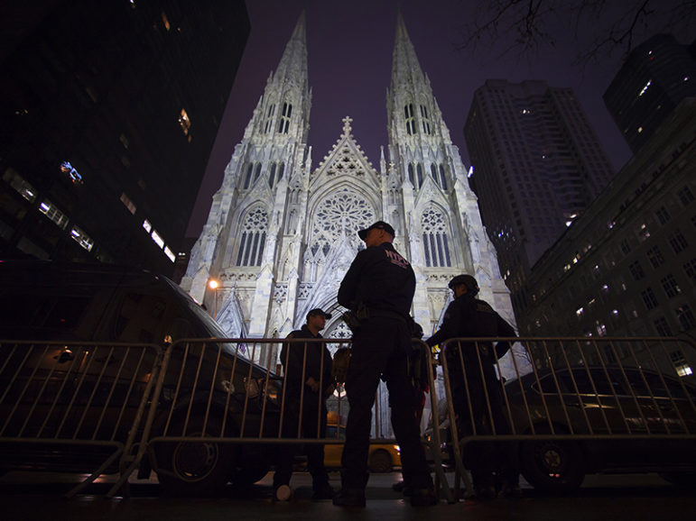 Police stand guard outside St Patrick's Cathedral during midnight mass in the Manhattan borough of New York on Dec. 25, 2014.  Photo courtesy of Reuters/Carlo Allegri