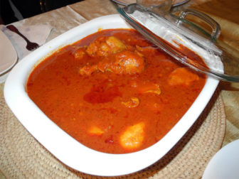 A traditional Nigerian Christmas dish of stewed chicken and tomatoes served over rice. Photo courtesy of Okey Ndibe