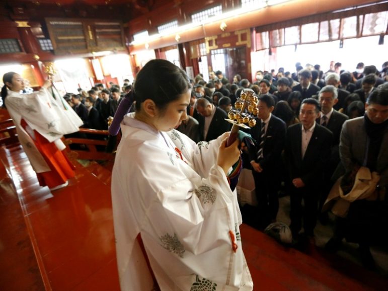 Shinto maidens tinkle bells during a ceremony for companies wishing for prosperous business in front of an altar at the start of the new business year Jan. 4, 2017, at Kanda Myojin Shrine, which is known to be frequented by worshippers seeking good luck and prosperous businesses, in Tokyo. Photo by Toru Hanai/Reuters