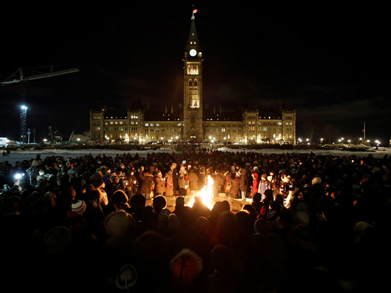People gather around the Centennial Flame on Parliament Hill during a vigil following a deadly shooting at a Quebec City mosque, in Ottawa, Ontario, Canada, January 30, 2017. Photo courtesy of REUTERS/Chris Wattie