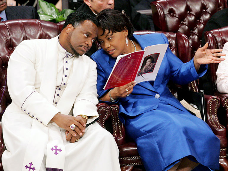 Bishop Eddie Long, left, speaks to the Rev. Bernice King, daughter of Coretta Scott King, during a  funeral for the elder King at  New Birth Missionary Baptist Church in Lithonia, Ga., on Feb. 7, 2006. Photo courtesy of Retuers/Ric Feld