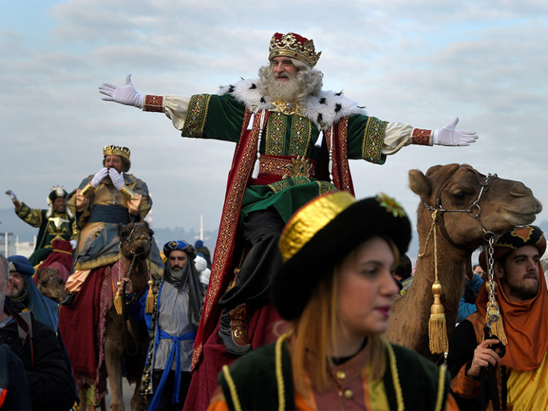 A man dressed as one of the Three Kings greets people during the Epiphany parade in Gijon, Spain, on  Jan. 5, 2017. Photo courtesy of Reuters/Eloy Alonso