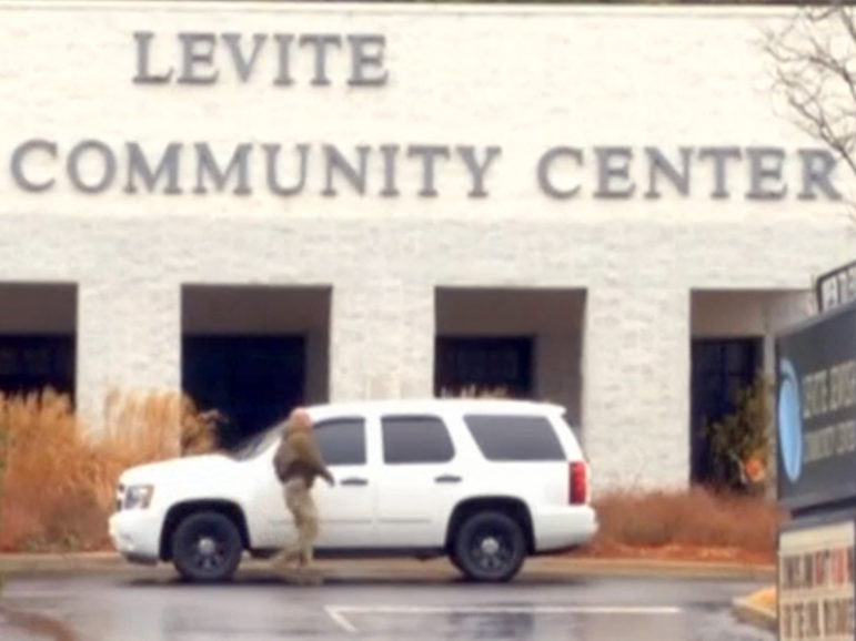An officer responds to a bomb threat at the Levite Jewish Community Center in Birmingham, Ala. Screenshot from video