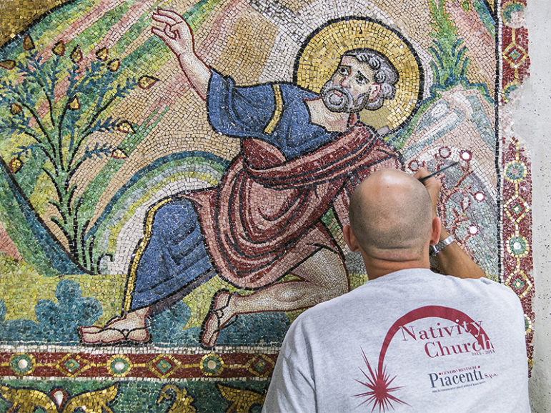 A restorer works on a wall of mosaic tiles in the Church of the Nativity in Bethlehem.  Photo courtesy of Piacenti SpA