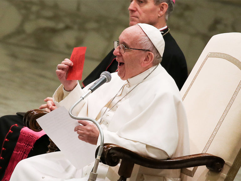 Pope Francis shows a free ticket during his Wednesday general audience in Paul VI Hall at the Vatican on Jan. 11, 2017. Photo courtesy of Reuters/Alessandro Bianchi 