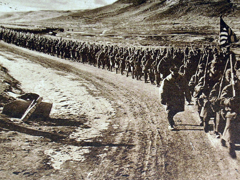 American troops walking along a road during World War I. Photo courtesy of Creative Commons