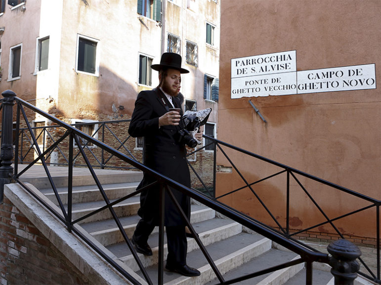 Jewish tourists stroll over one of the bridges that delineate the borders of the ghetto of Venice in northern Italy on March 22, 2016.  Photo courtesy of Reuters/Alessandro Bianchi