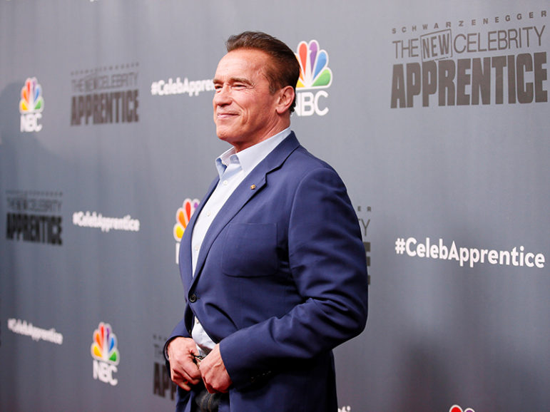 Host Arnold Schwarzenegger poses after a panel for 