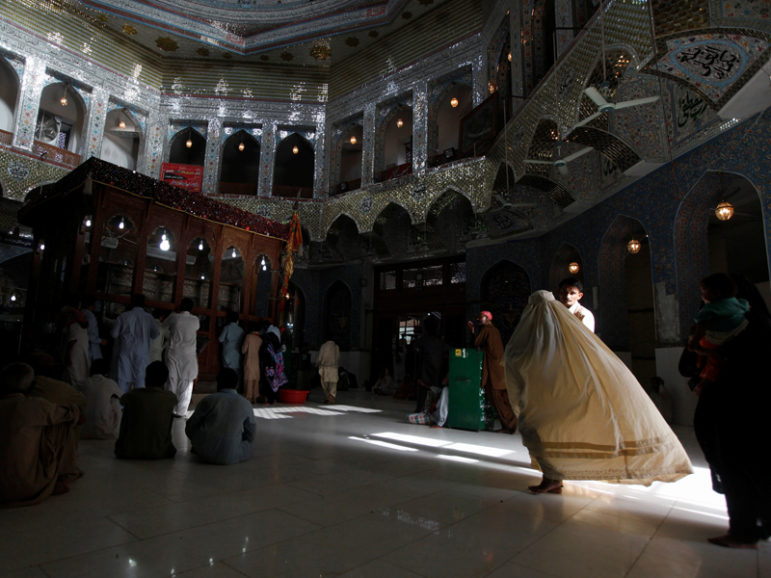 A woman clad in burqa walks in the hallway of the tomb of Sufi saint Syed Usman Marwandi, also known as Lal Shahbaz Qalandar, in Sehwan Sharif, in Pakistan's southern Sindh province, on Sept. 5, 2013. Photo courtesy Reuters/Akhtar Soomro