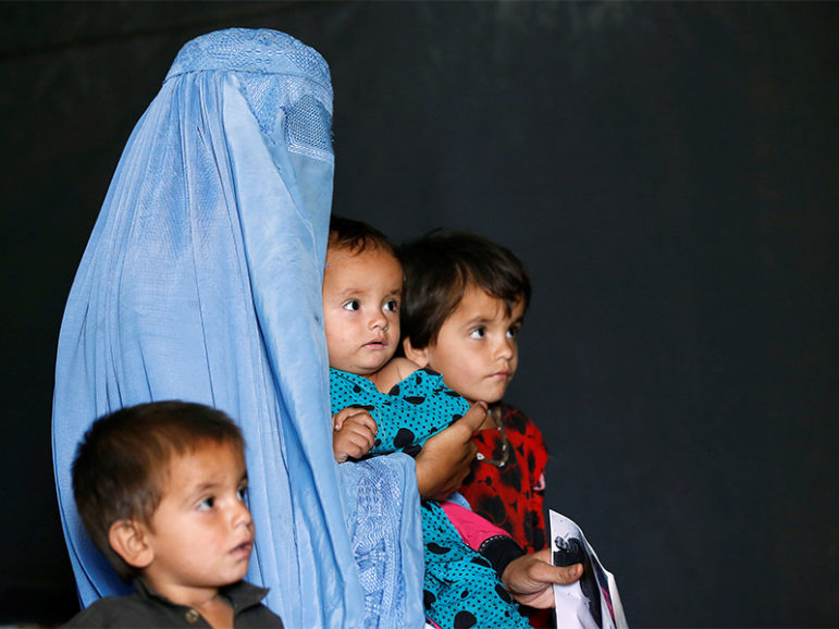 An Afghan family, with the mother wearing a burqa, at a United Nations High Commissioner for Refugees (UNHCR) registration centre in Kabul, Afghanistan, on Sept. 27, 2016.  Photo courtesy of Reuters/Mohammad Ismail