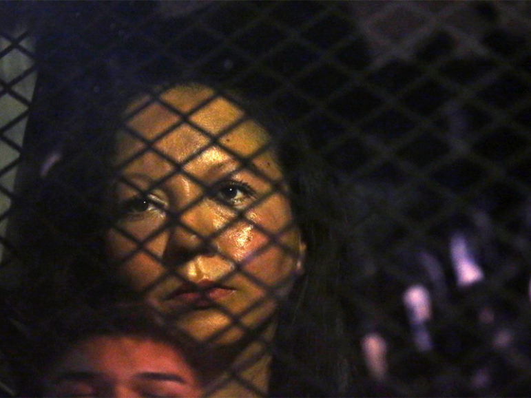 Guadalupe Garcia de Rayos is locked in a van that is stopped in the street by protesters outside the Immigration and Customs Enforcement facility on Feb. 8, 2017, in Phoenix. Photo by Rob Schumacher/The Arizona Republic