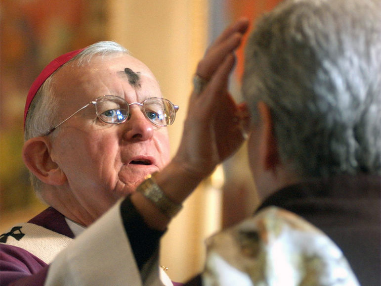 The Most Rev. John G. Vlazny, his forehead smudged with ashes, performs the Ash Wednesday ceremony on parishioners in Portland, Ore., in 2005. Photo by Michael Lloyd