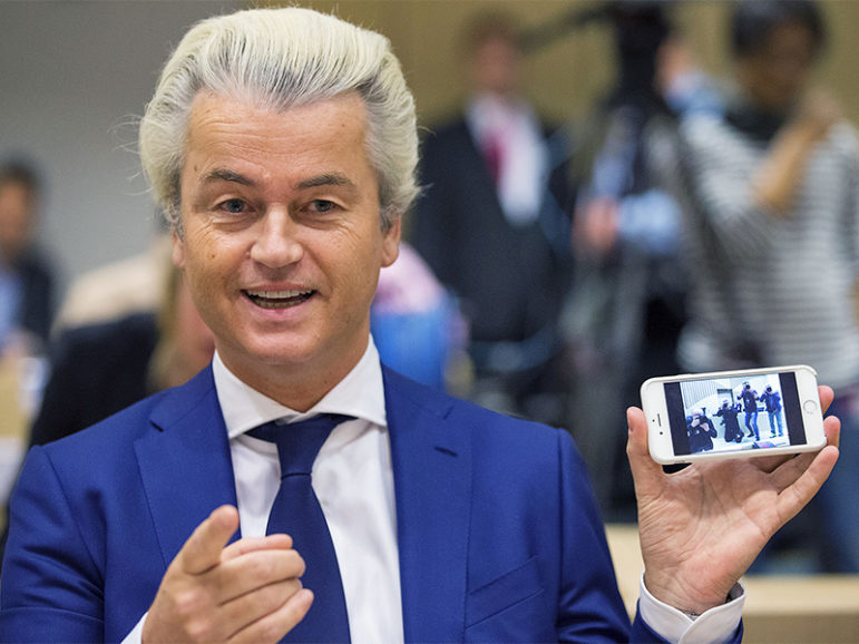 Dutch far-right Party for Freedom (PVV) leader Geert Wilders shows the picture of the photographers he took with his cellphone before his trial in Schiphol, the Netherlands, on March 18, 2016. Photo courtesy of Reuters/Michael Kooren
