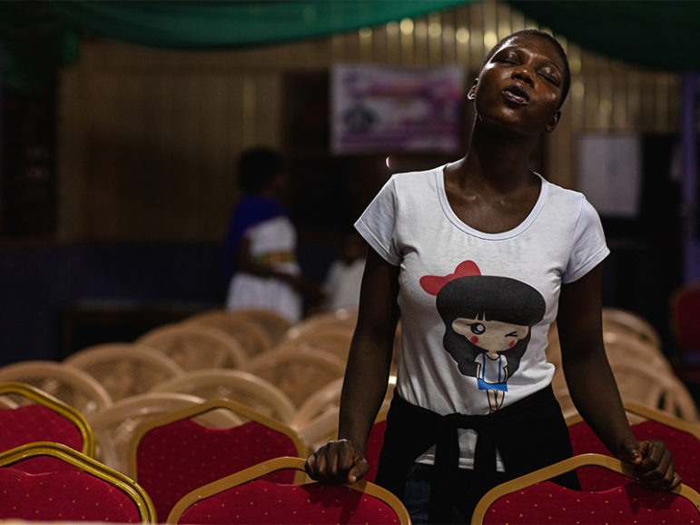 A member of the Victory Bible Church, Peniel Sanctuary, prays to usher in the New Year in Accra, Ghana, on Dec. 31, 2016. Photo courtesy of Reuters/ Francis Kokoroko