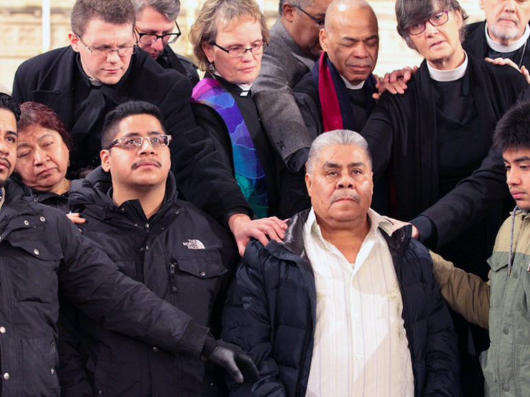 People with Faith in New Jersey, part of the PICO Network, pray around Catalino Guerrero, center right, an immigrant from Mexico who fears deportation. Photo courtesy of Heather Wilson/PICO National Network