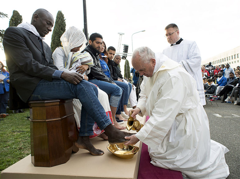 Pope Francis washes the foot of a refugee during the foot-washing ritual at the Castelnuovo di Porto refugees center near Rome on March 24, 2016. Pope Francis washed and kissed the feet of refugees, including three Muslim men. Handout photo courtesy of Reuters/Osservatore Romano