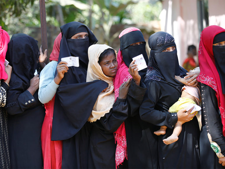 Rohingya women wait in line with vouchers to collect relief distributed by the Bangladesh Red Crescent Society at Kutupalang Unregistered Refugee Camp in Coxís Bazar, Bangladesh, on Feb. 6, 2017. Photo courtesy of Reuters/Mohammad Ponir Hossain