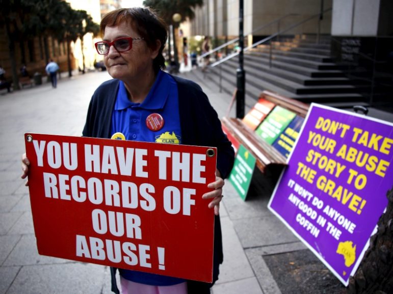 An abuse victim only known as Val holds a placard as she stands outside the venue for Australia's Royal Commission into Institutional Response to Child Sexual Abuse March 2, 2016, in Sydney, Australia. Photo by David Gray/REUTERS