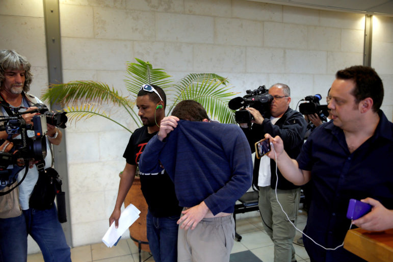 An U.S.-Israeli teen who was arrested in Israel on suspicion of making bomb threats against Jewish community centres in the United States, Australia and New Zealand over the past three months, is seen before the start of a remand hearing at Magistrate's Court in Rishon Lezion, Israel, on March 23, 2017. Photo courtesy of Reuters/Baz Ratner