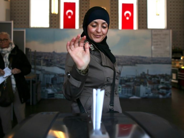 A woman wearing an Islamic headscarf votes March 15, 2017, in the general elections in a mosque in Amsterdam. Photo by Cris Toala Olivares/Reuters
