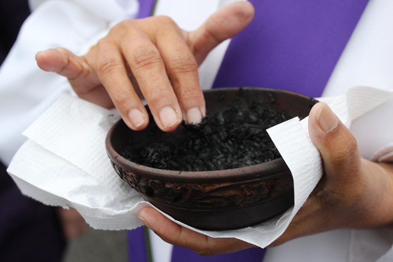 The Rev. Saroj Sangha of Glenmont United Methodist Church in Silver Spring, Md., holds a container of ashes on Ash Wednesday in her church’s parking lot on March 1, 2017. RNS photo by Adelle M. Banks